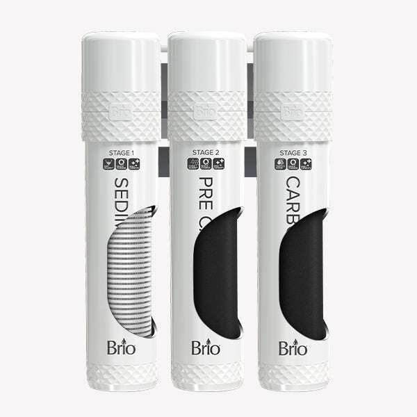 Three white cylindrical Brio water filter cartridges labeled “Sediment,” “Pre Carbon,” and “Carbon,” are arranged side by side, each with a partial cutout showing the filter inside.